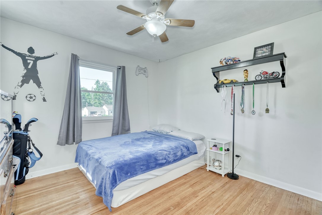 1038 Whalen Road Penfield, NY 14526 - Photo 19 of 46 Bedroom number one with ceiling, fan and hardwood