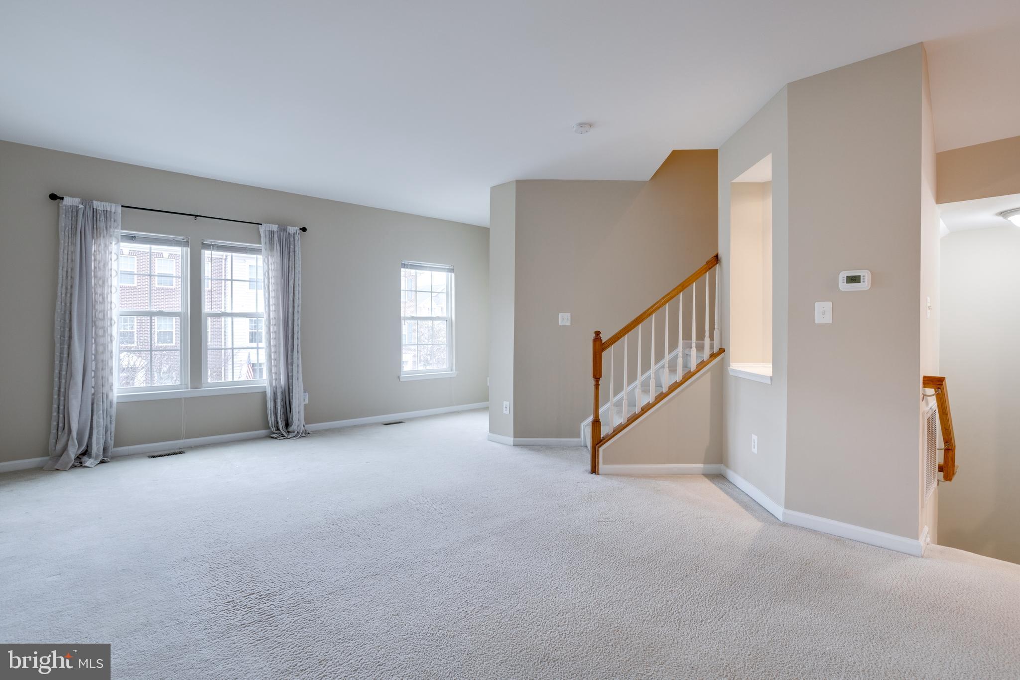 7012 Trek Way Gainesville, VA 20155 - Photo 12 of 33 a view of an empty room with window and stairs