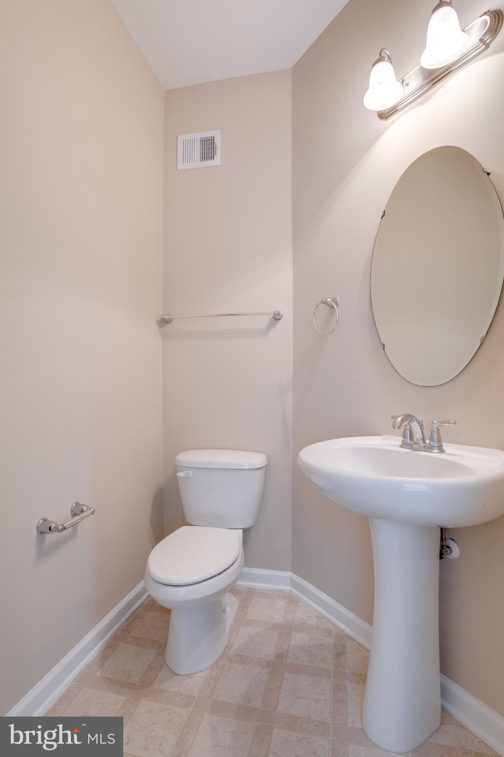 7012 Trek Way Gainesville, VA 20155 - Photo 13 of 33 a bathroom with a toilet sink and mirror