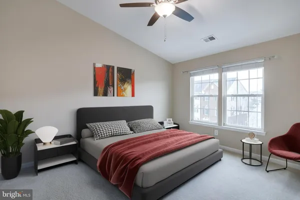 a bedroom with a bed couch and window