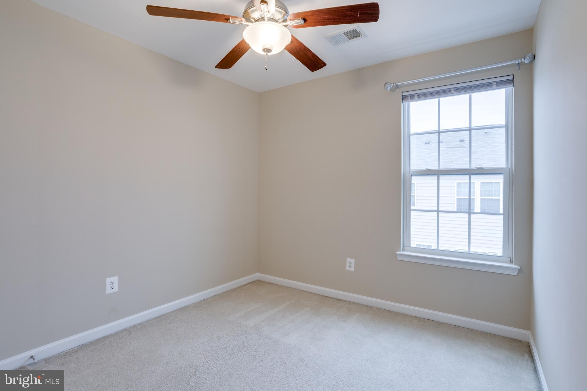 7012 Trek Way Gainesville, VA 20155 - Photo 24 of 33 an empty room with a window and a fan