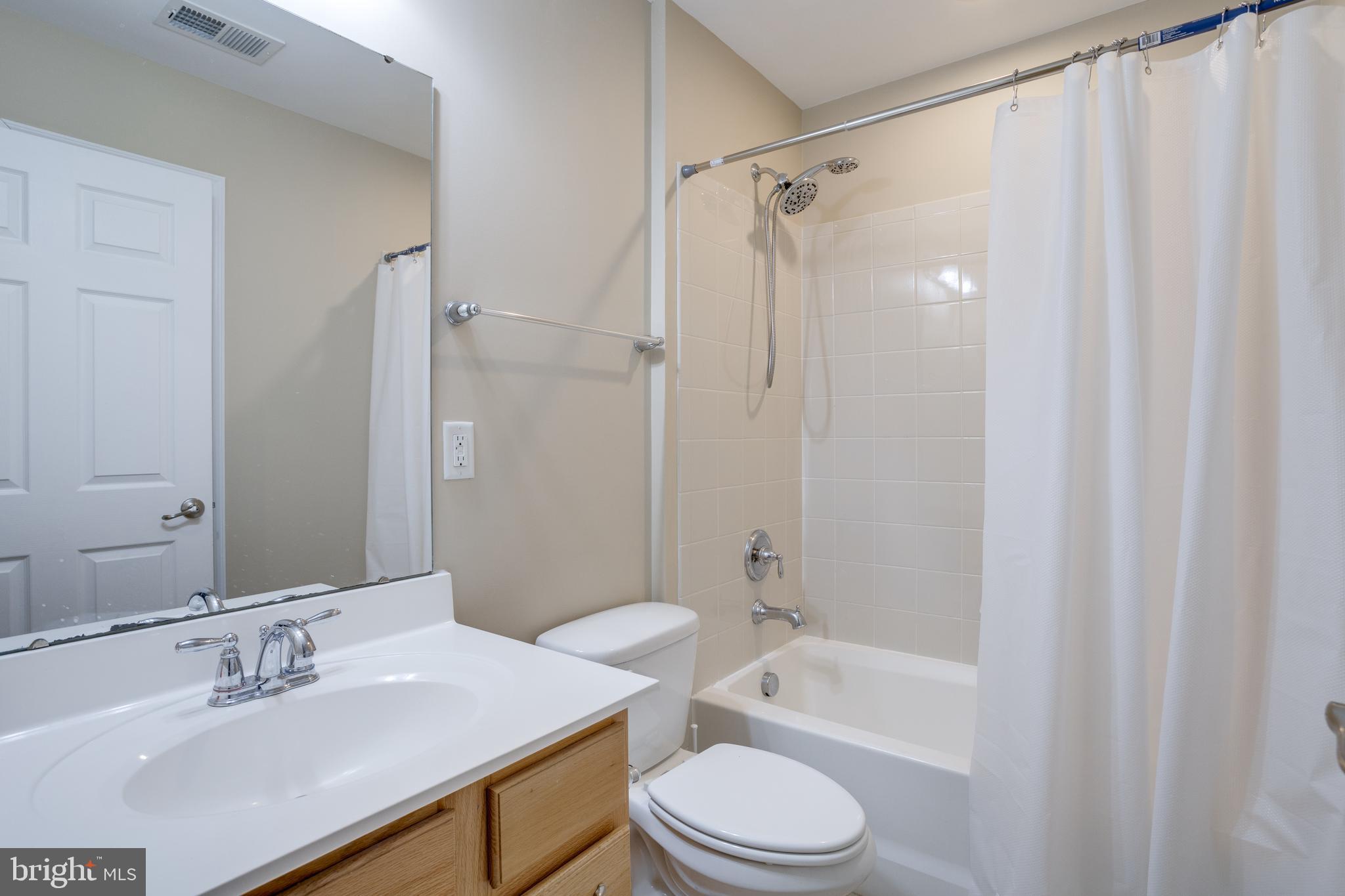 7012 Trek Way Gainesville, VA 20155 - Photo 25 of 33 a bathroom with a sink a toilet a mirror and shower