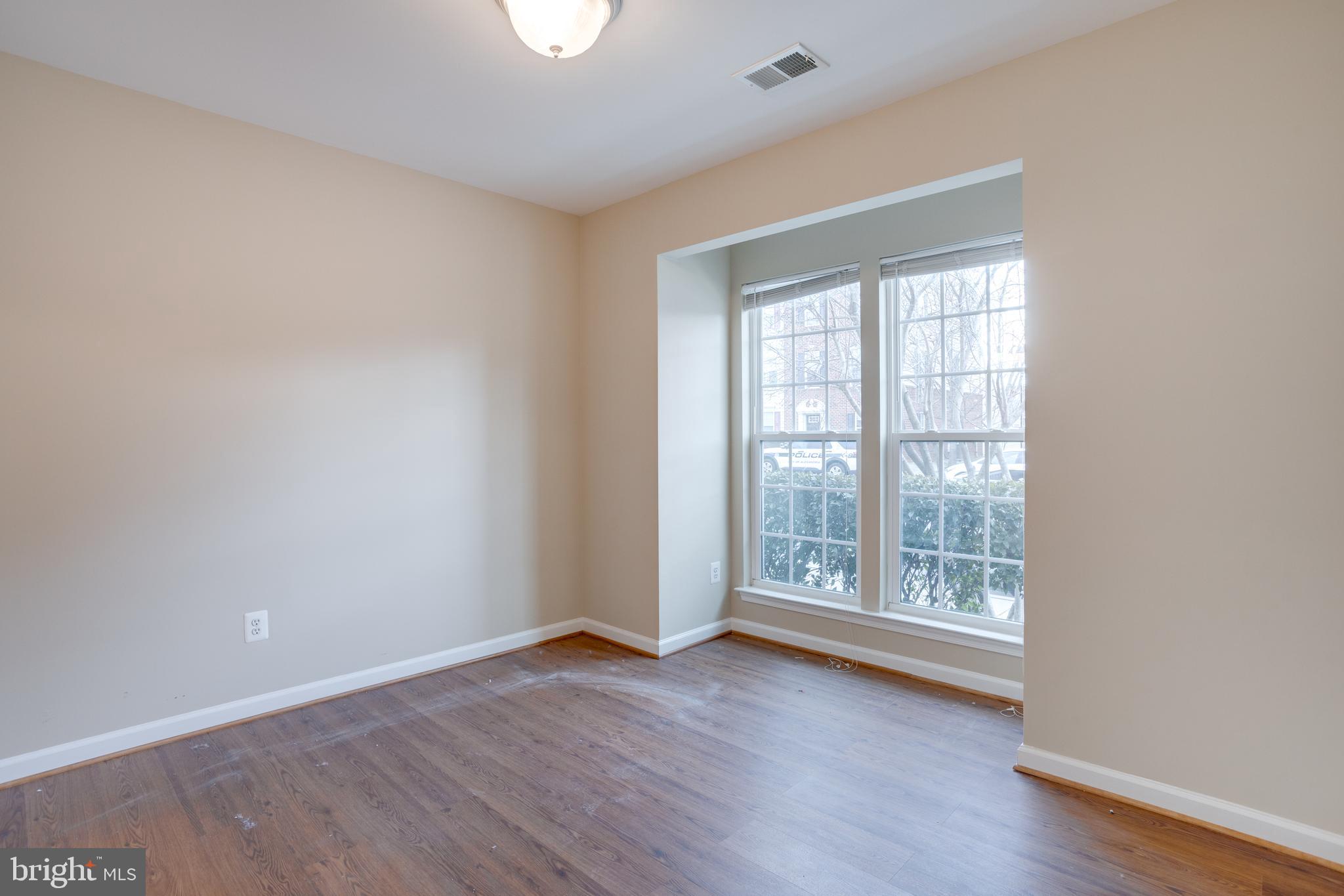 7012 Trek Way Gainesville, VA 20155 - Photo 28 of 33 an empty room with wooden floor and windows