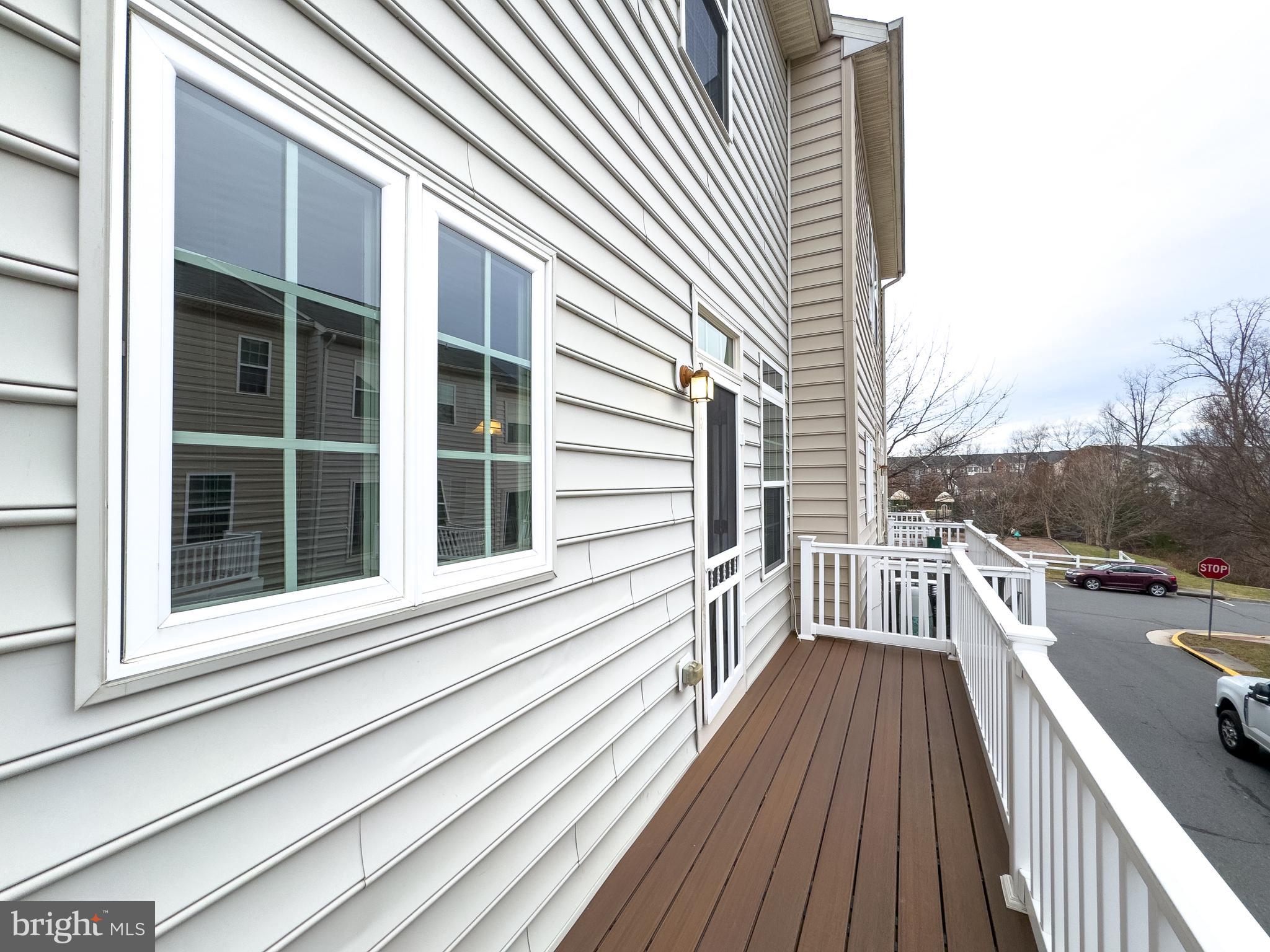7012 Trek Way Gainesville, VA 20155 - Photo 30 of 33 a view of a balcony with wooden floor and fence