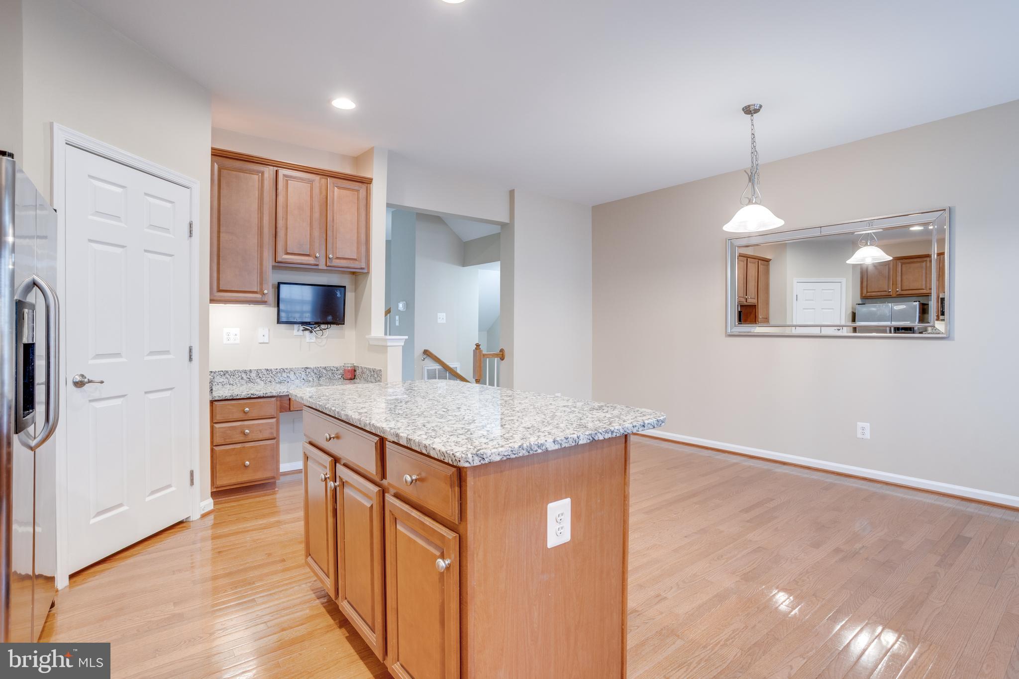 7012 Trek Way Gainesville, VA 20155 - Photo 8 of 33 a kitchen with stainless steel appliances granite countertop a sink stove and refrigerator