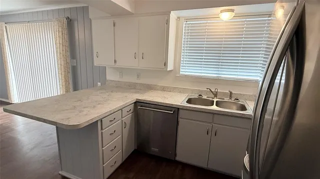 a kitchen with a sink cabinets and window