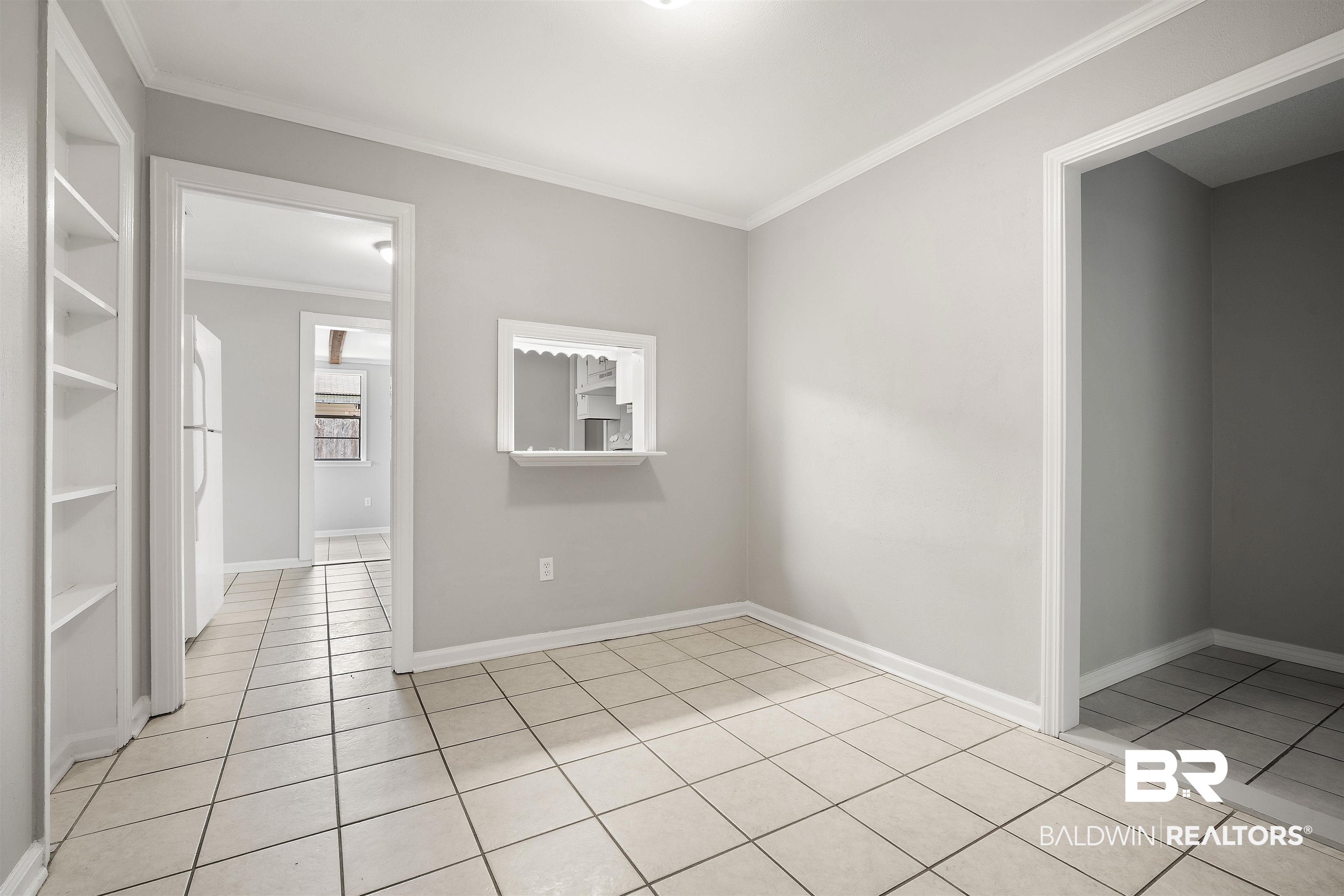 963 Shady Brook Drive Mobile, AL 36606 - Photo 11 of 20 Spare room with light tile patterned floors, crown molding, and baseboards