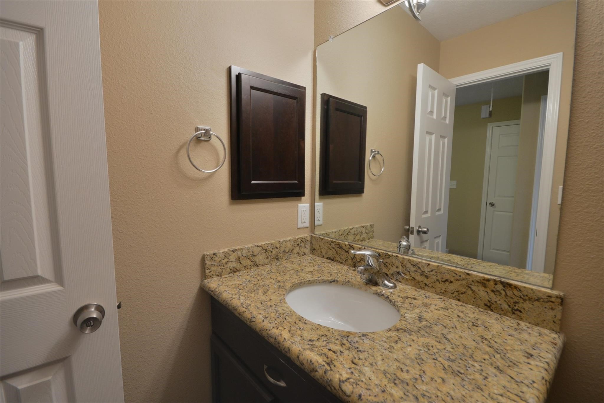 106 Eddy Street, Unit B Humble, TX 77338 - Photo 19 of 22 a bathroom with a granite countertop sink and mirror