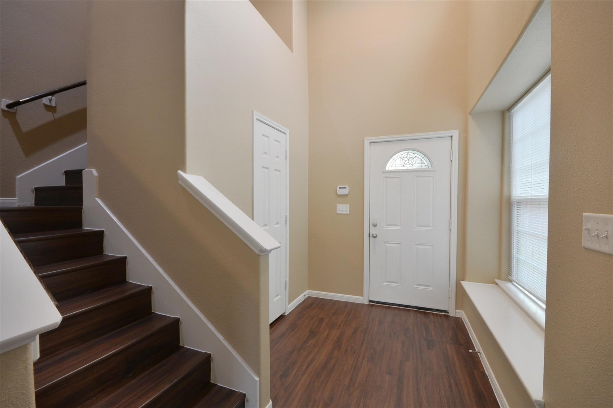 106 Eddy Street, Unit B Humble, TX 77338 - Photo 2 of 22 a view of an entryway with wooden floor and stairs