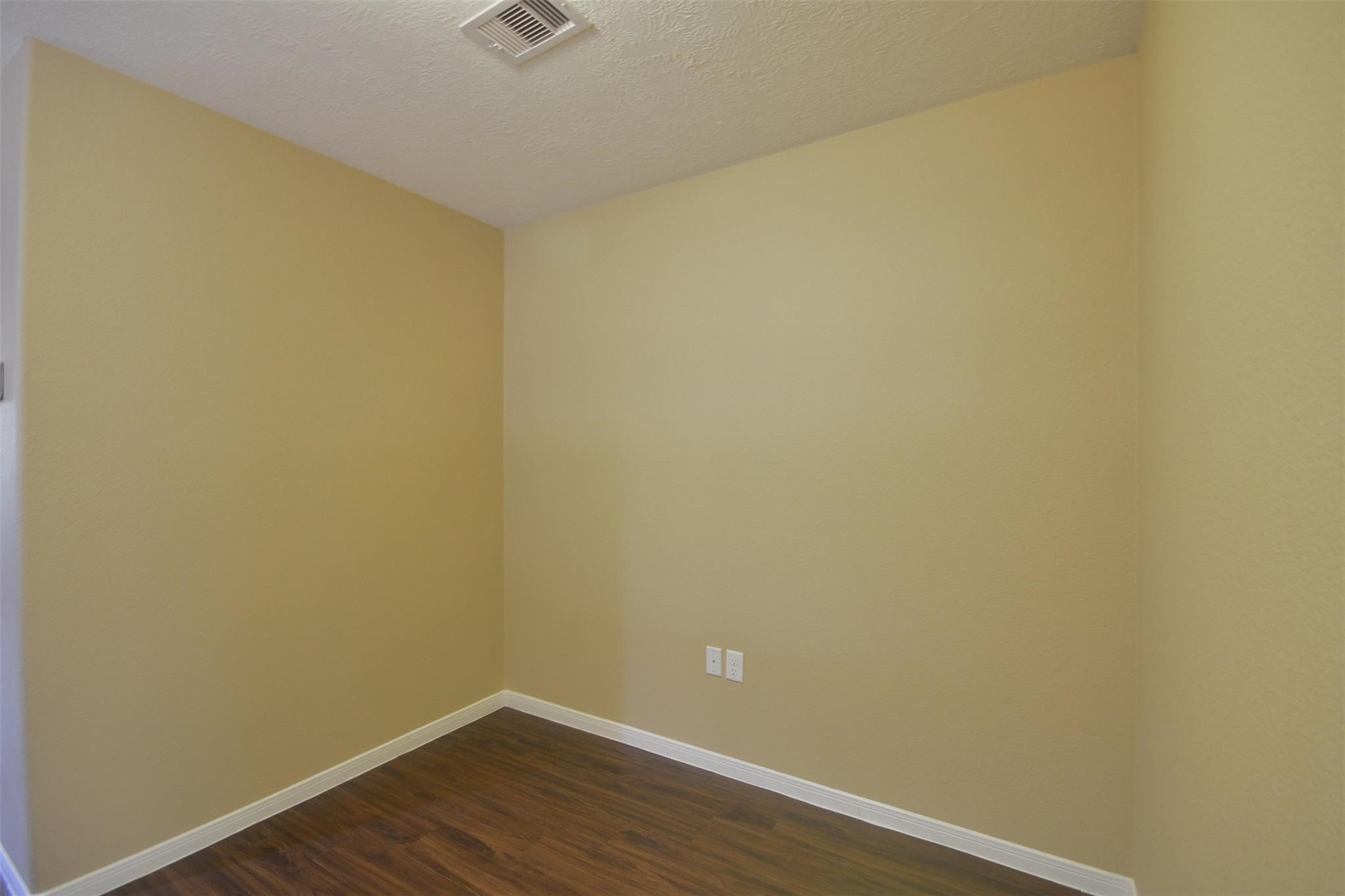 106 Eddy Street, Unit B Humble, TX 77338 - Photo 21 of 22 a view of a small space with wooden floor and a window