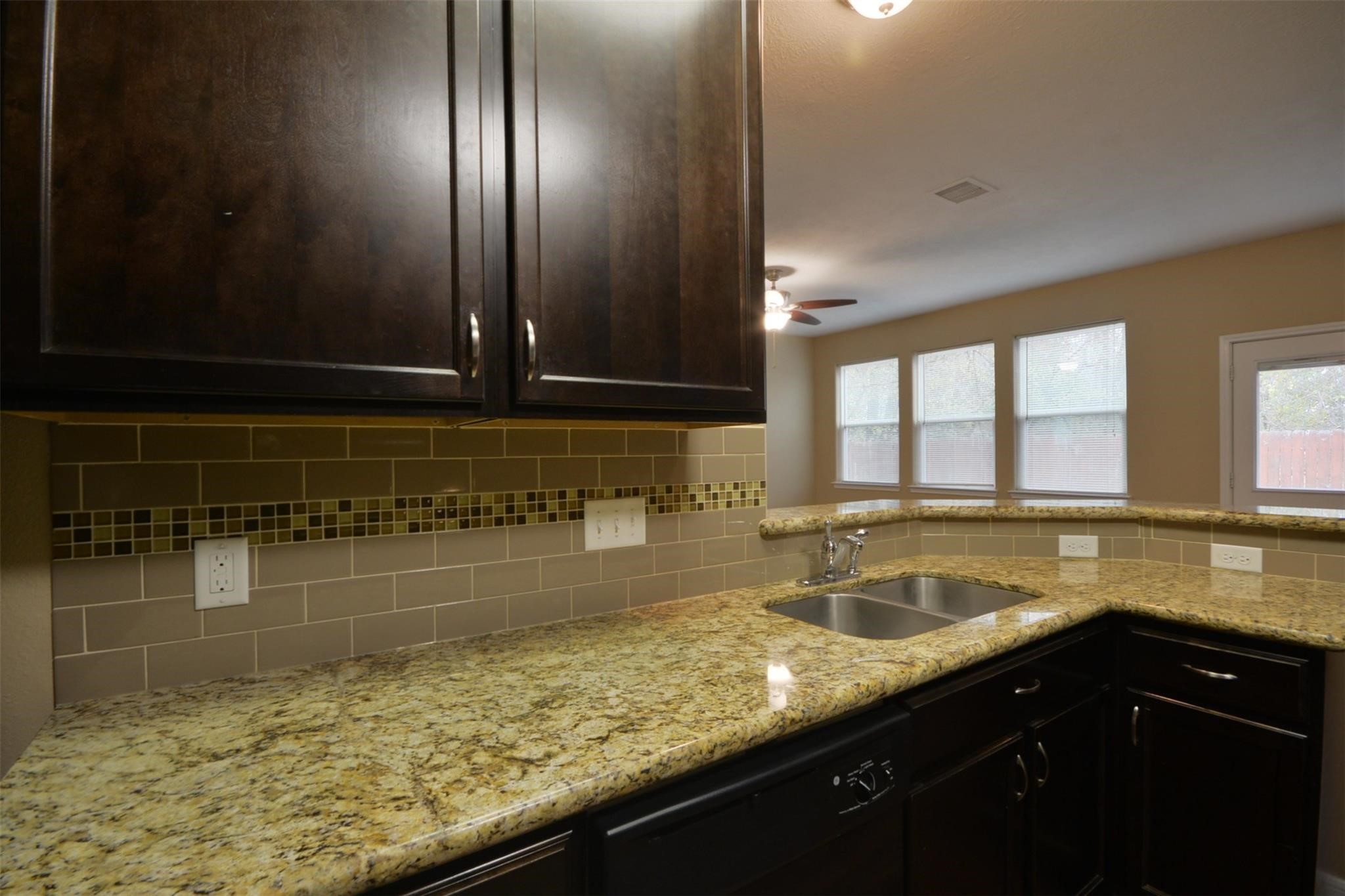 106 Eddy Street, Unit B Humble, TX 77338 - Photo 8 of 22 a kitchen with a sink a counter top space and cabinets