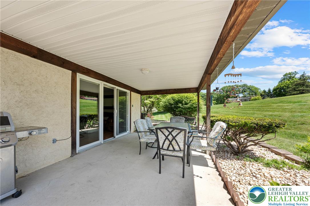 947 Tamenend Road Bath, PA 18014 - Photo 42 of 61 An inviting covered patio with sliding glass doors offers a tranquil outdoor retreat.