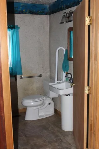 a bathroom with a toilet and a sink