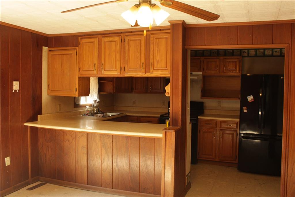 567 Klein Road Sandy Lake, PA 16145 - Photo 10 of 27 a kitchen with a refrigerator and cabinets