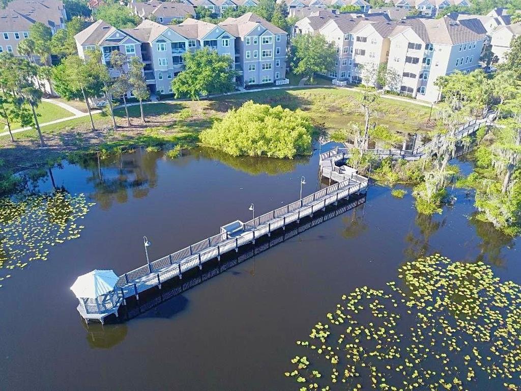 3280 Soho Street, Unit 307 Orlando, FL 32835 - Photo 24 of 34 a view of a lake with a building in the background