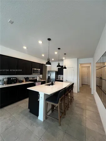 a large kitchen with a table and chairs in it