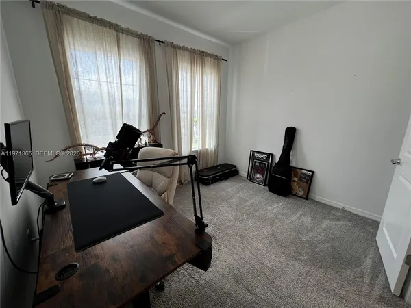 a room with gym equipment and windows