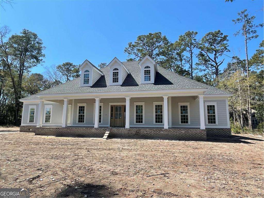 119 Hampton Point Drive St. Simons Island, GA 31522 - Photo 1 of 37 a front view of a house with a yard