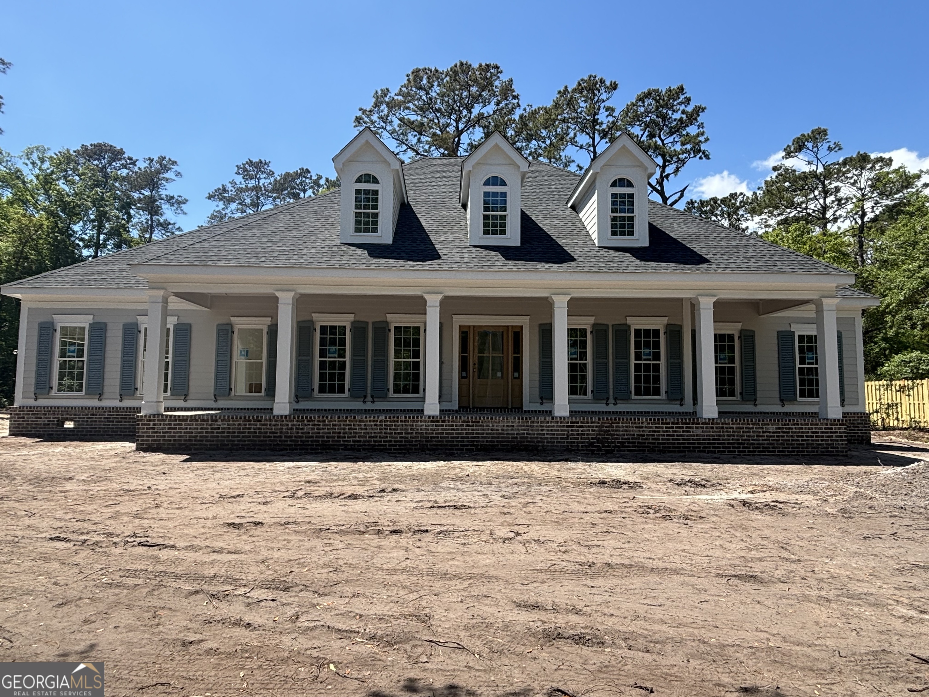 119 Hampton Point Drive St. Simons Island, GA 31522 - Photo 2 of 37 a front view of a house with a yard