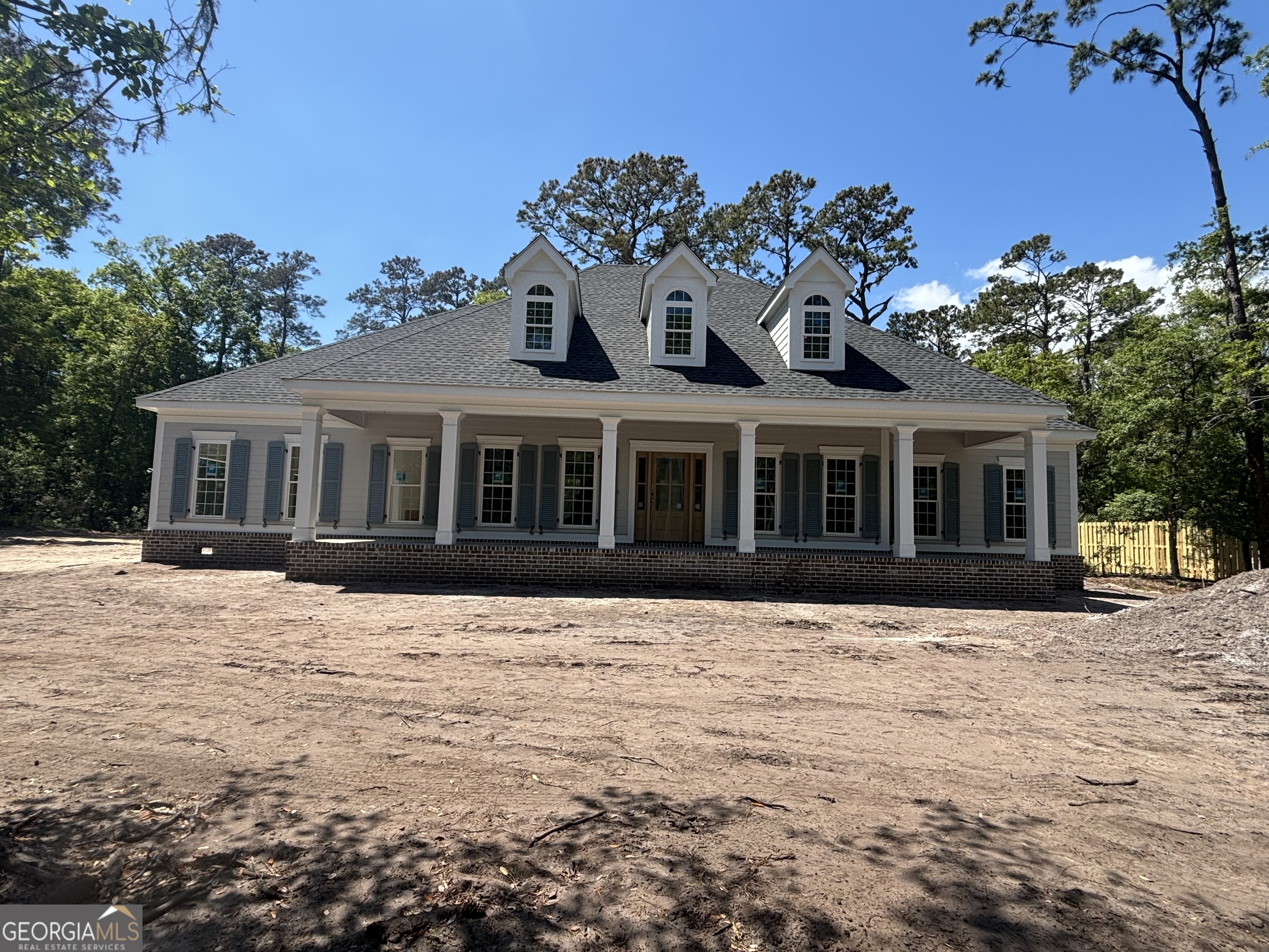 119 Hampton Point Drive St. Simons Island, GA 31522 - Photo 3 of 37 a front view of a house with a yard