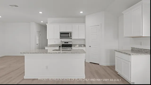 a view of kitchen with microwave and cabinets