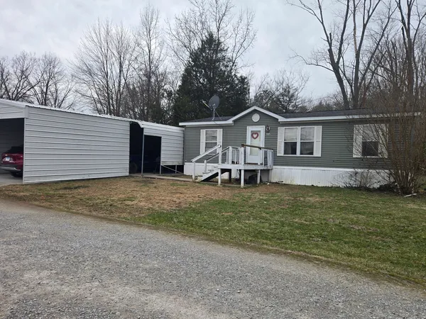 a view of a house with a yard and sitting area