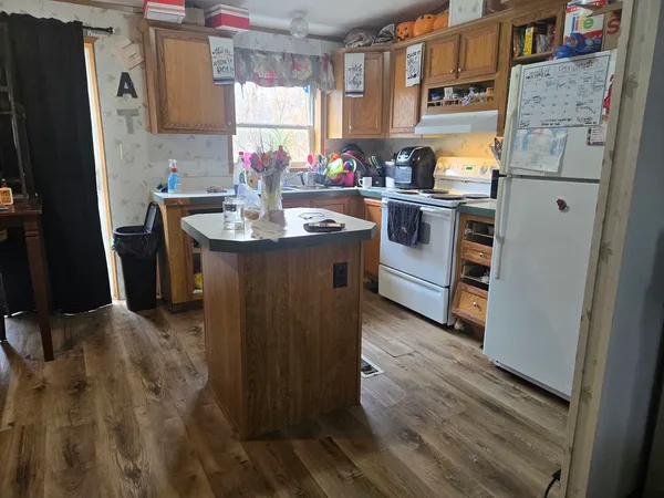 a kitchen with refrigerator and window