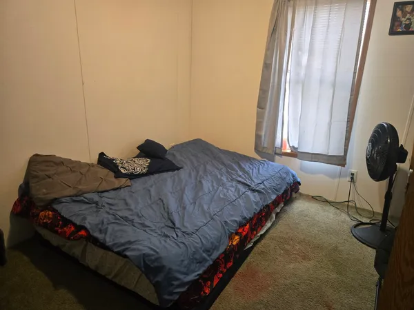 a bedroom with a bed and window
