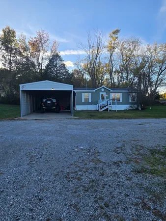 a view of a house with a yard and garage