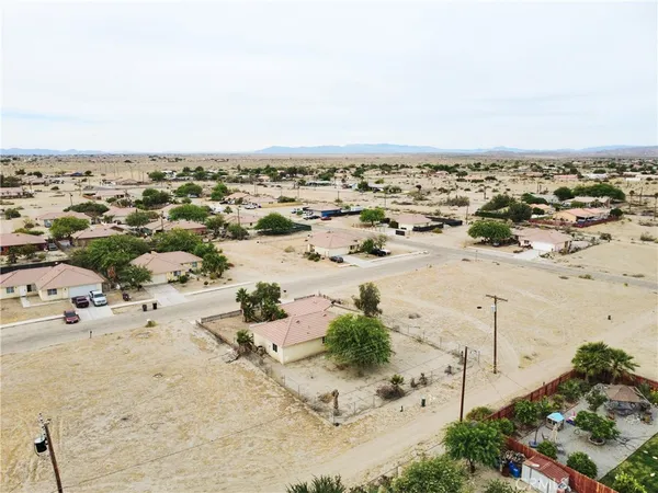 an aerial view of beach with residential building and ocean view