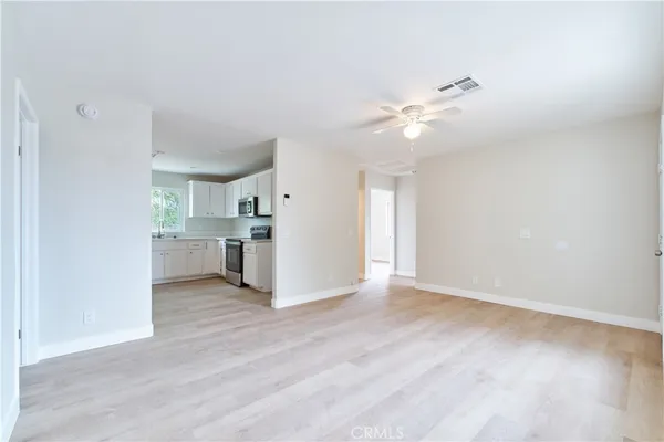 a view of a kitchen with wooden floor and a kitchen