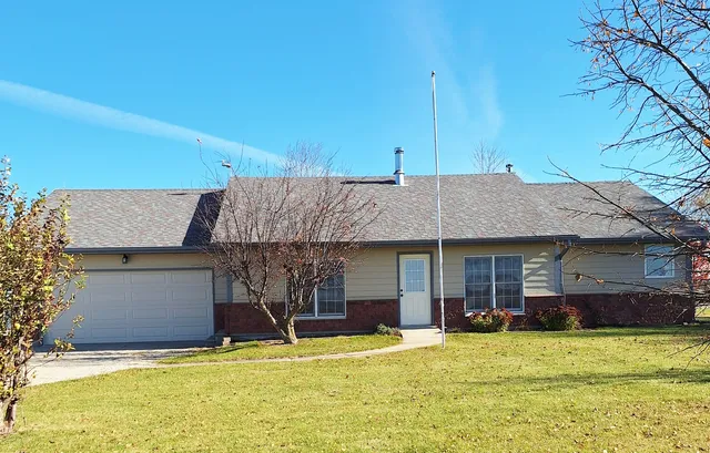 a view of a house with pool and a yard