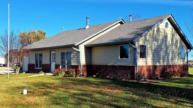 a view of a house with a yard patio and fire pit