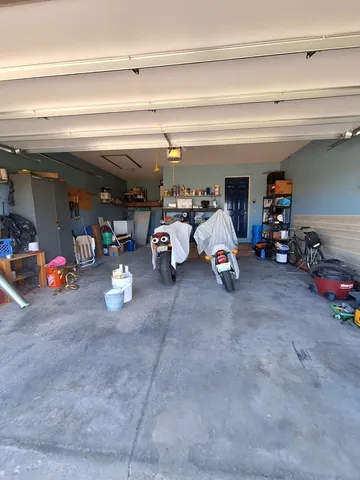 a view of a garage with a bike and car