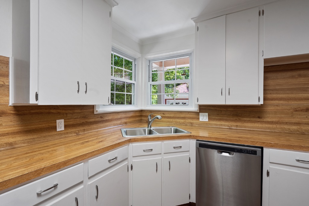 1212 Bentwood Road Austin, TX 78722 - Photo 11 of 32 a kitchen with a sink cabinets and window
