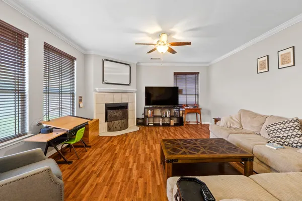 a living room with furniture a fireplace and a flat screen tv