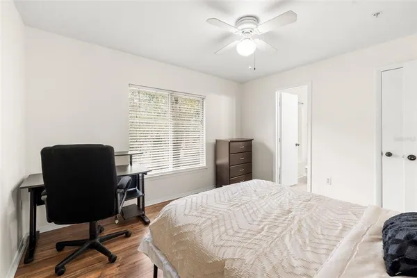 a bedroom with a large bed and a desk