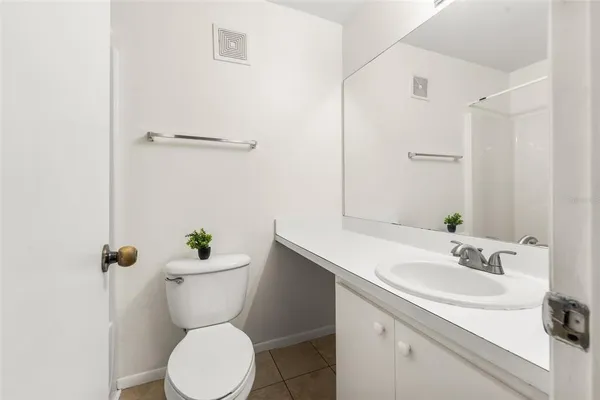 a bathroom with a sink mirror and toilet