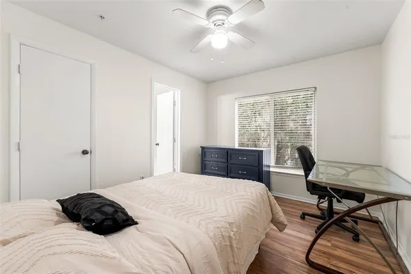 a bedroom with a bed window and a desk