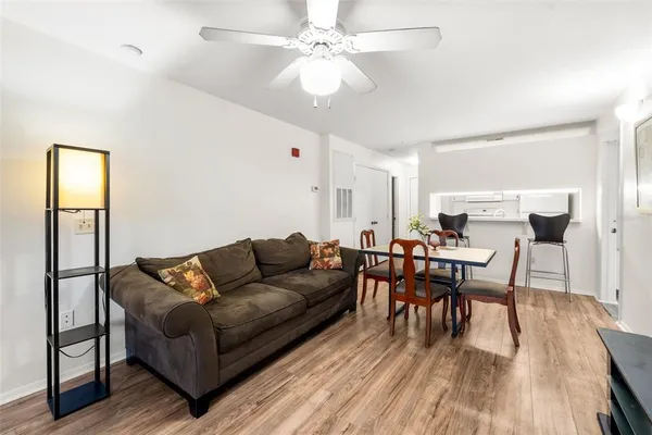 a living room with furniture and a wooden floor
