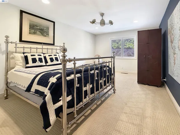 a view of a bedroom with furniture and window