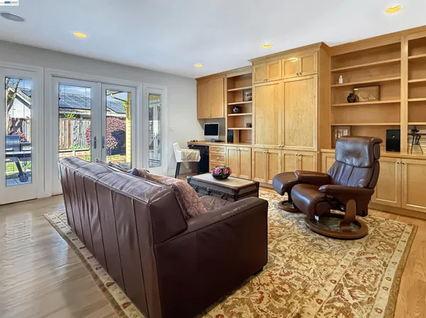 a living room with furniture fireplace and a window