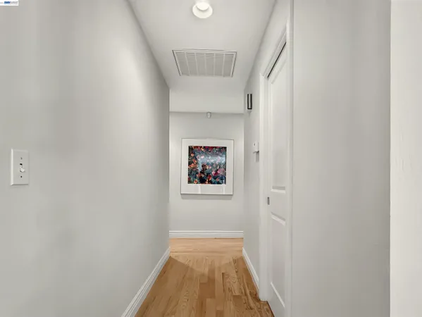 a view of hallway with wooden floor