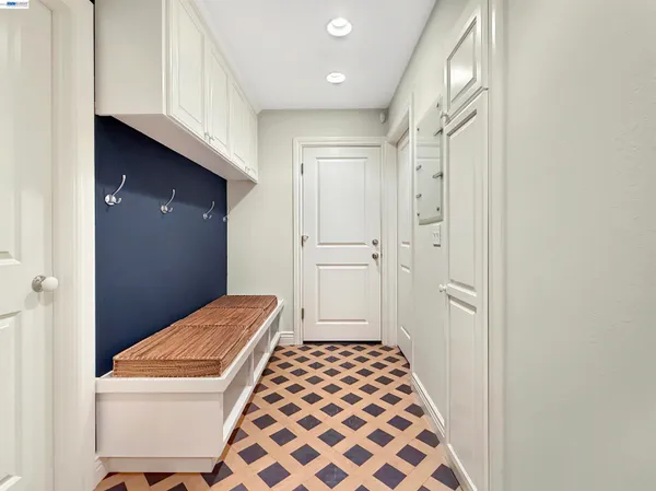 a bedroom with a bed and a black white checkered kitchen