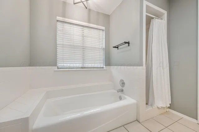 a white bath tub sitting next to a window