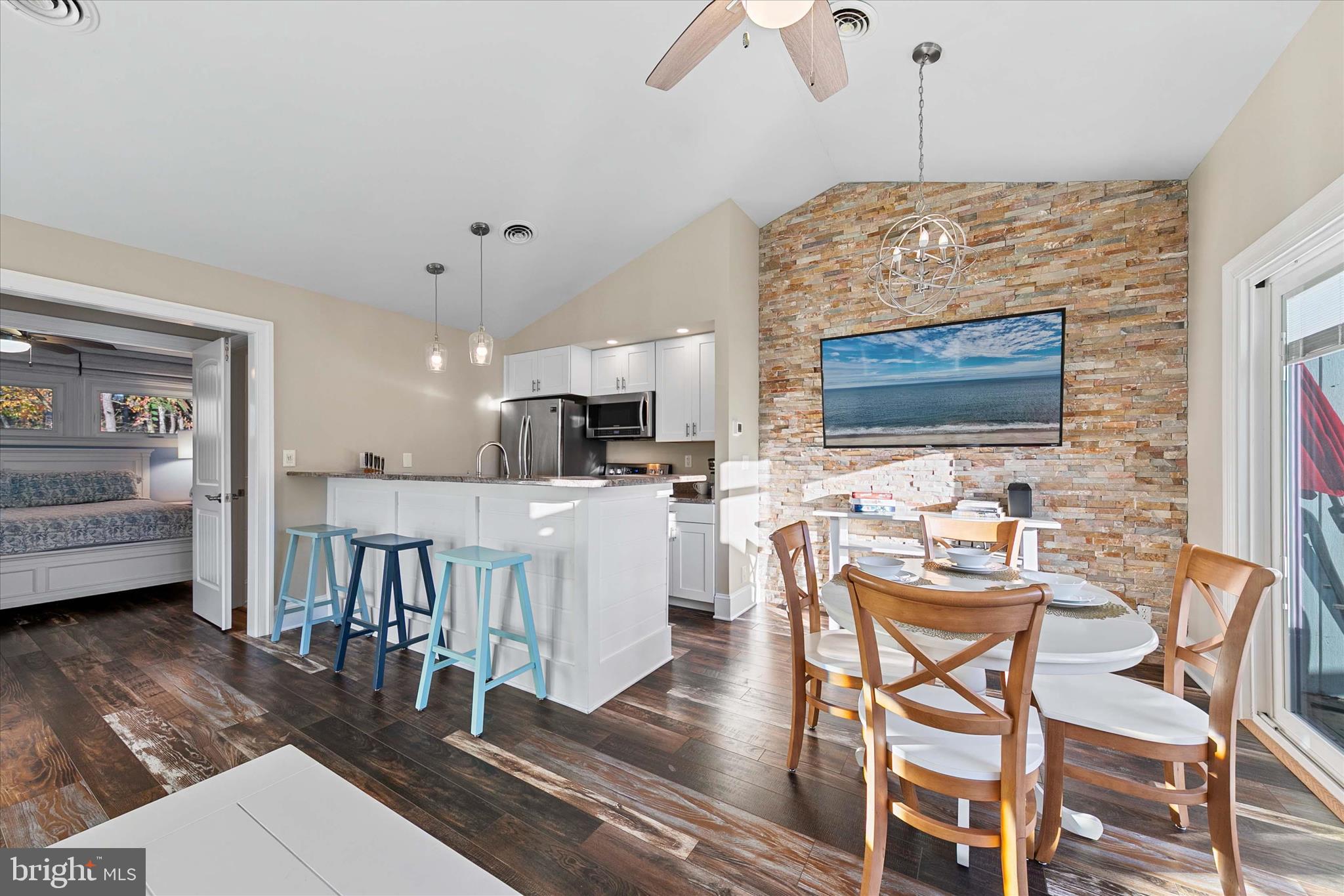 39655 Tie Breaker Court, Unit 4801 Bethany Beach, DE 19930 - Photo 14 of 58 a view of a dining room with furniture and wooden floor