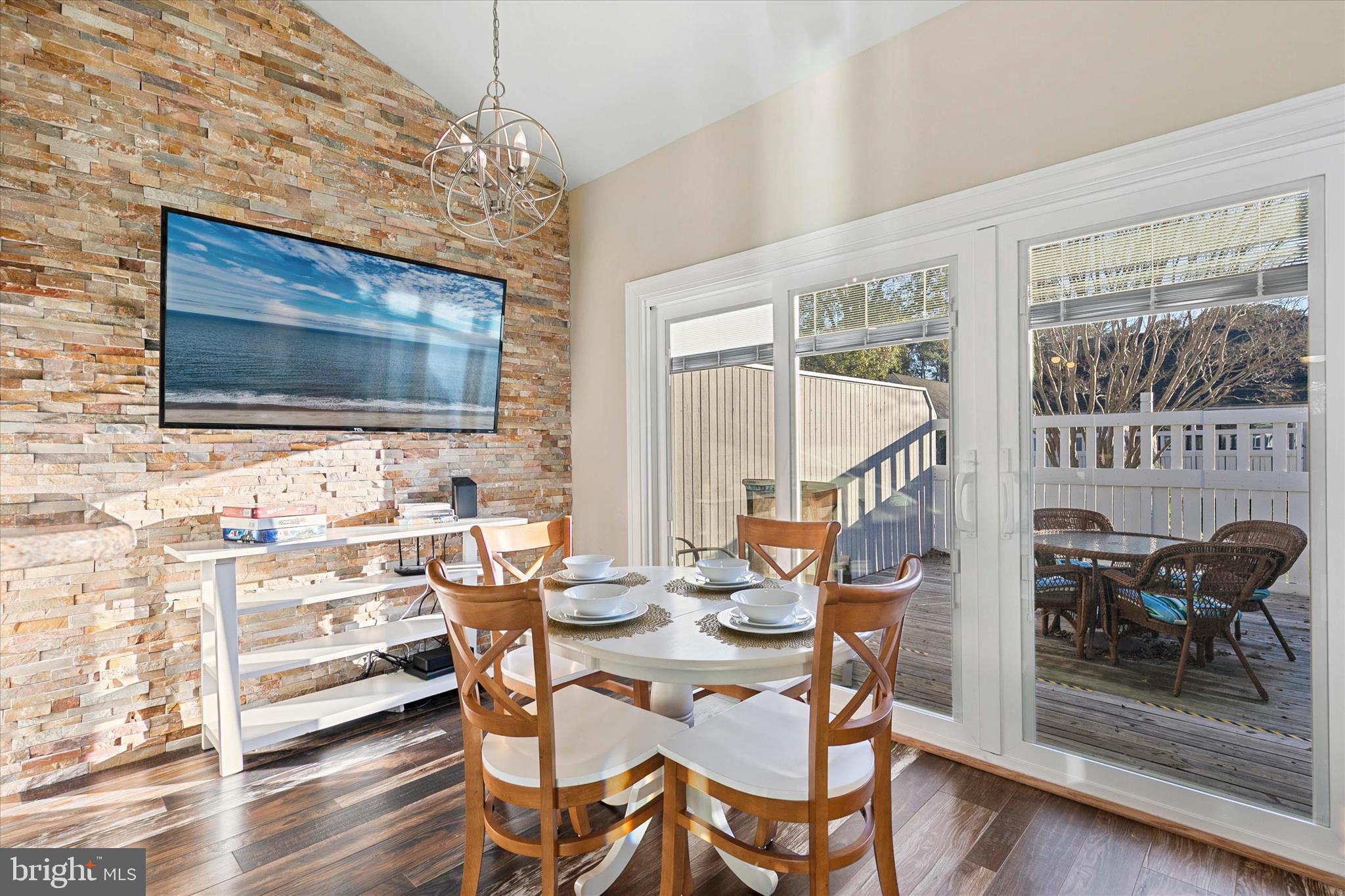 39655 Tie Breaker Court, Unit 4801 Bethany Beach, DE 19930 - Photo 15 of 58 a view of a dining room with furniture wooden floor and chandelier