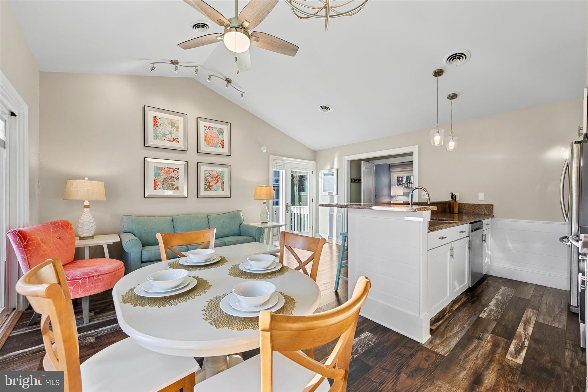 39655 Tie Breaker Court, Unit 4801 Bethany Beach, DE 19930 - Photo 17 of 58 a open dining room with stainless steel appliances kitchen island granite countertop a dining table and chairs with wooden floor