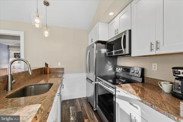 a kitchen with a stove and a microwave