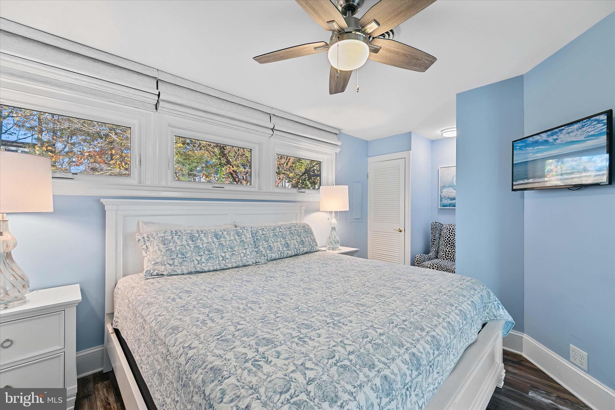 39655 Tie Breaker Court, Unit 4801 Bethany Beach, DE 19930 - Photo 26 of 58 a bedroom with a large bed and a chandelier